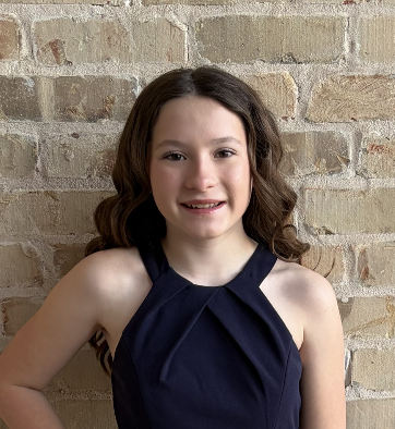 Lainey Combs photographed in front of a brick wall